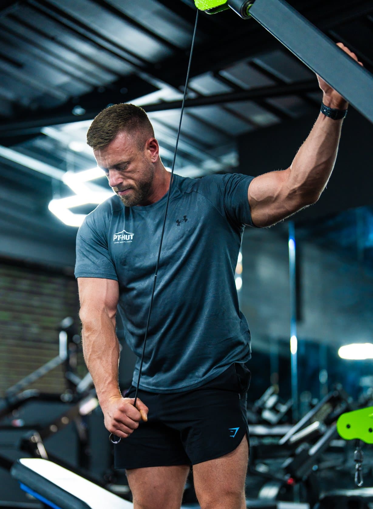 Clinton Coffey working a single-arm cable exercise